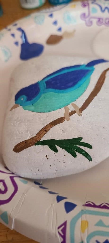 Rock stencil adding color to tree