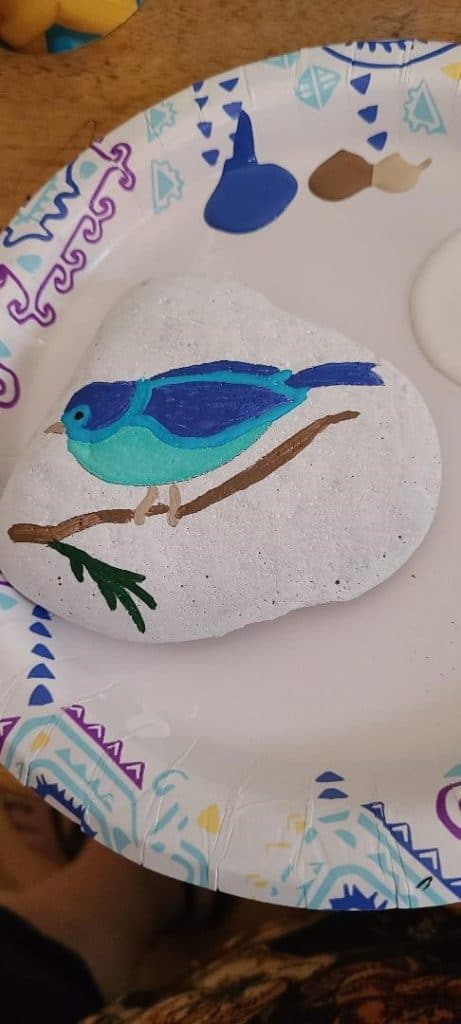 Rock stencil bird finishing touches