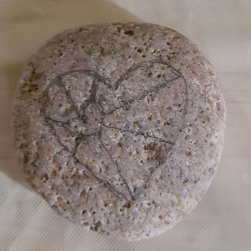 Drawing the heart on a rock