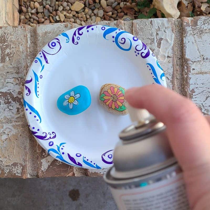 Daisy painted rocks - sealing rocks