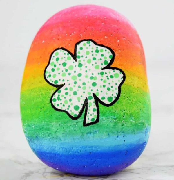 Four leaf clover painted rainbow rock by Ruffles & Rain Boots