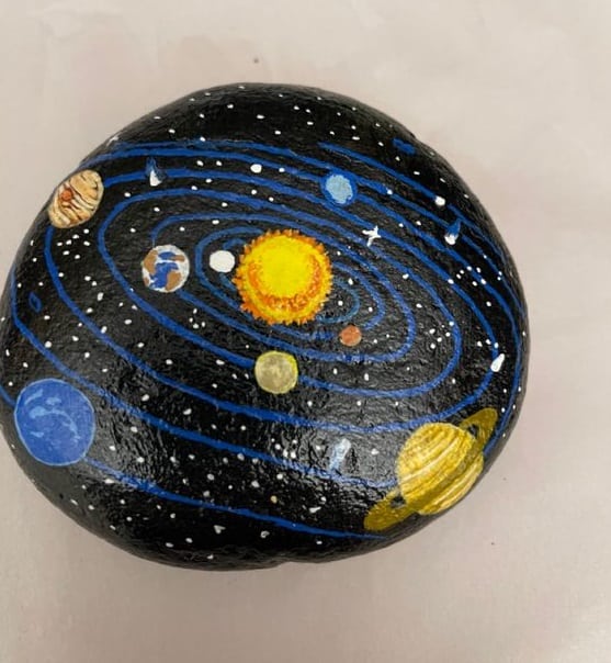 Solar system painted rock by Shelia Powell