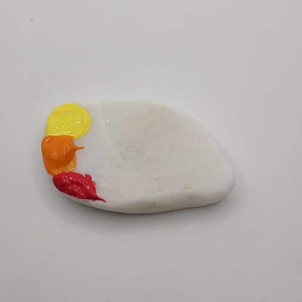 sunset painted rocks palm applying paint