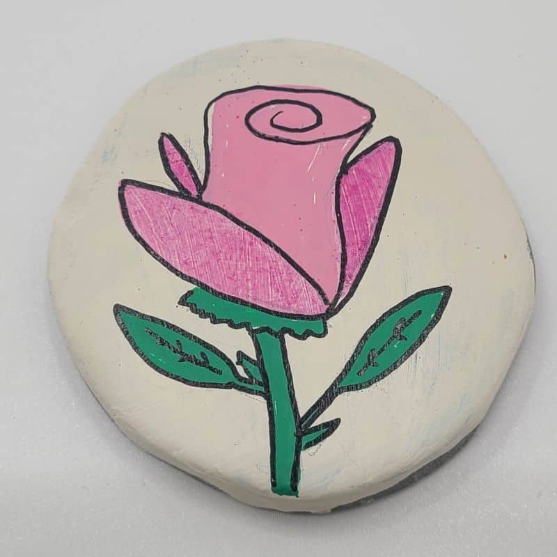 rose painted rocks adding detail