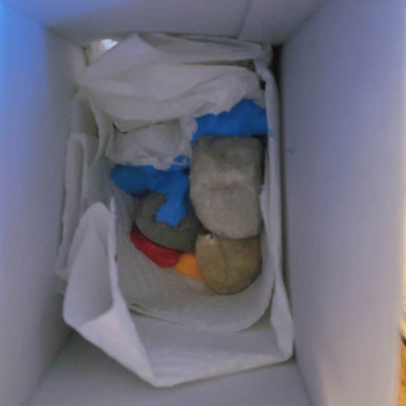 adding rocks to the box